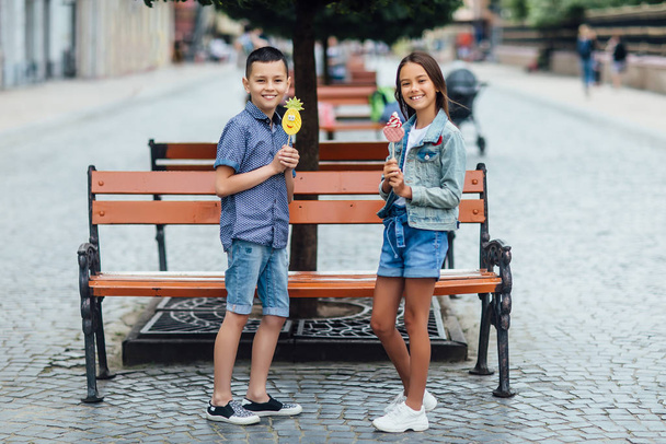 Two happy children with sweets, selective focus - Valokuva, kuva