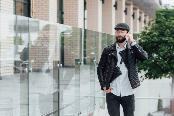stylish man using phone outdoors, selective focus - Fotoğraf, Görsel