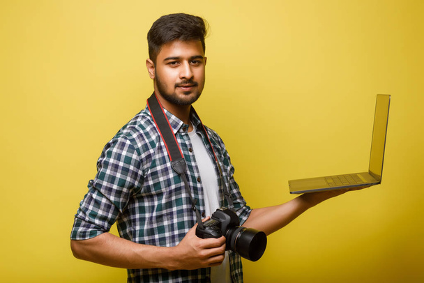 Young handsome man on yellow background - Foto, imagen