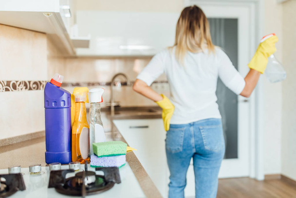 young woman cleaning kitchen, selective focus - Fotó, kép