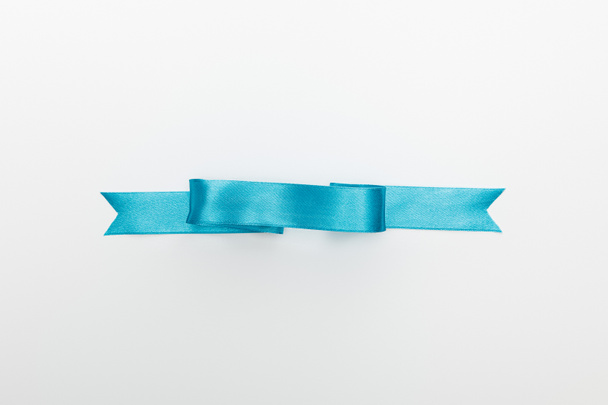 top view of blue decorative satin ribbon isolated on white - Foto, Bild