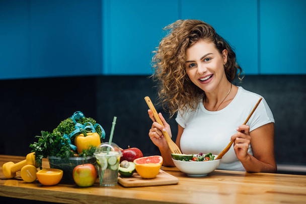 Beautiful woman with healthy green food at modern kitchen  - Foto, Imagen