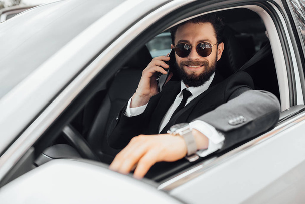 Handsome young businessman driving car, selective focus - Foto, imagen