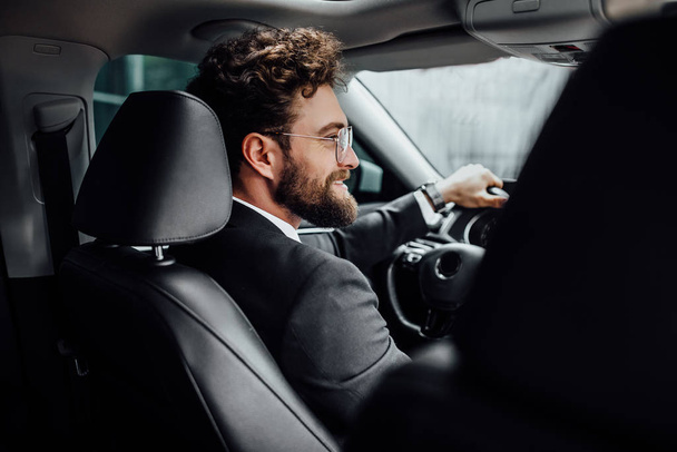 Handsome young businessman driving car, selective focus - Φωτογραφία, εικόνα