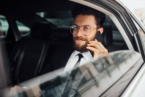 Handsome young businessman driving car, selective focus - Foto, immagini