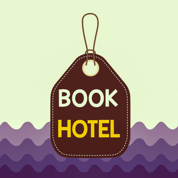 Text sign showing Book Hotel. Business photo showcasing an arrangement you make to have a hotel room or accommodation Empty tag blank space colorful background label rectangle attached string - Photo, Image