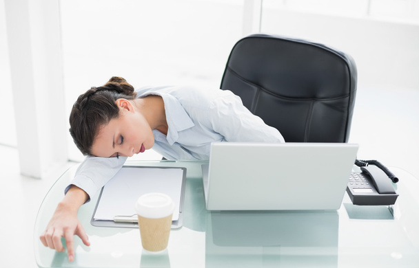 Sleepy stylish brunette businesswoman relaxing at her desk - Foto, Imagem