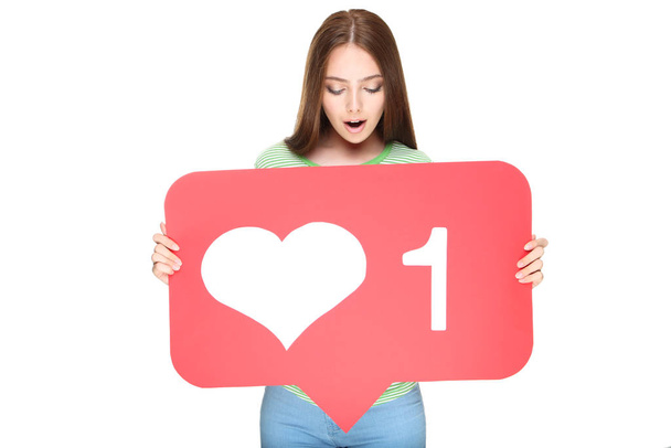 Young woman holding paper card with heart and number one on whit - 写真・画像