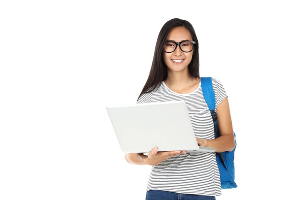 Beautiful young woman with laptop computer and backpack on white - Fotoğraf, Görsel