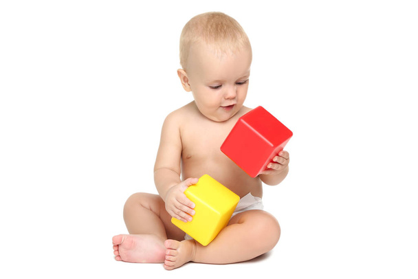 Beautiful little boy in diaper with plastic cubes isolated on wh - Foto, imagen