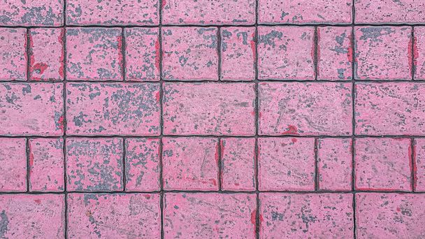 abstract background of tiles painted pink on the track in the park close up - Photo, Image