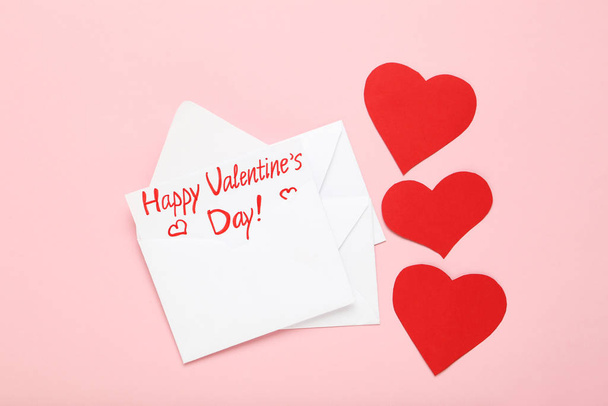 Paper envelopes with red hearts and text Happy Valentines Day on pink background - Foto, Bild