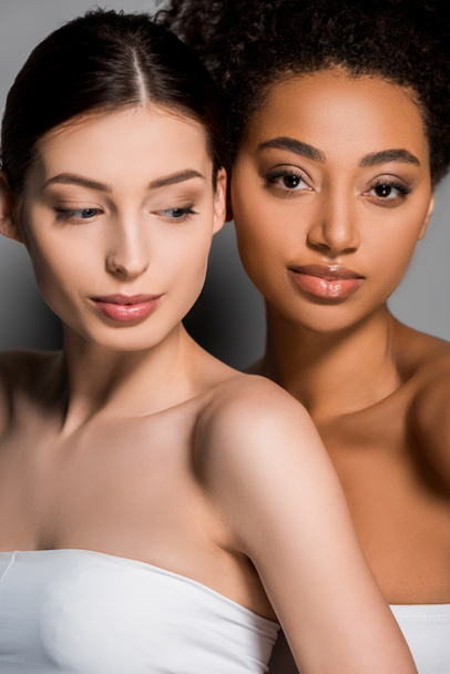 portrait of beautiful young multicultural women, on grey - 写真・画像