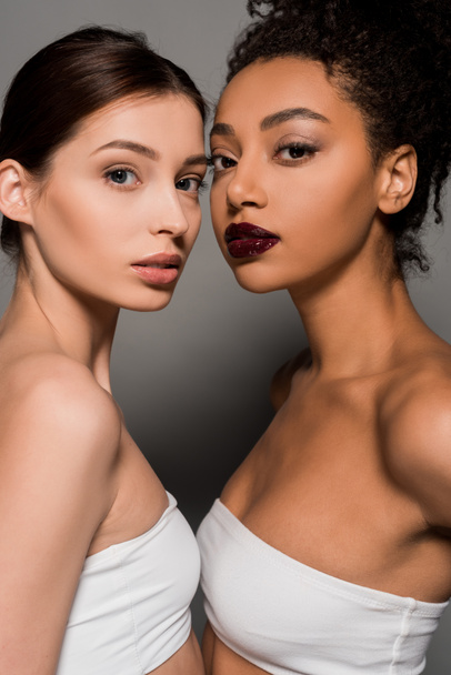 portrait of beautiful multicultural girls with perfect skin on grey - Zdjęcie, obraz