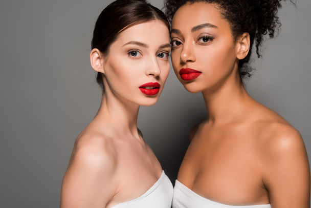 attractive multicultural women with red lips, on grey  - Zdjęcie, obraz