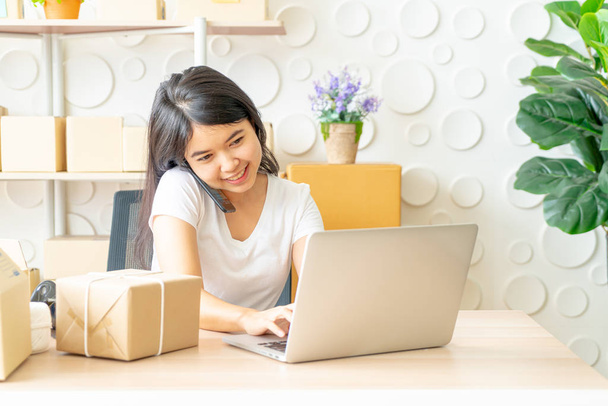 Asian woman enjoy herself while using internet on laptop and pho - Φωτογραφία, εικόνα