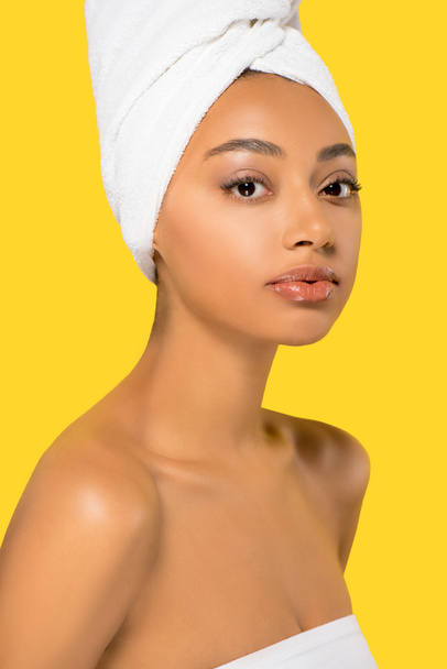 portrait of attractive african american girl with towel on head, isolated on yellow - Foto, Bild