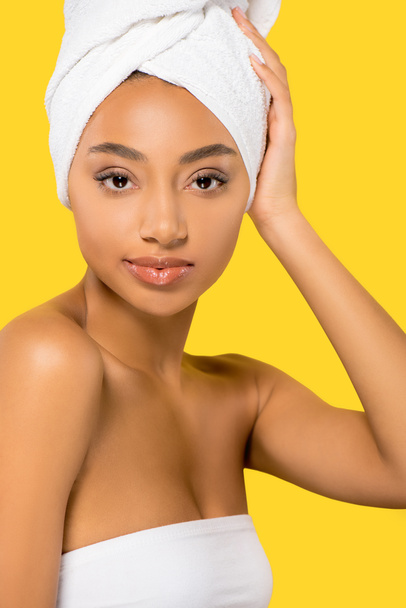 portrait of african american young woman with towel on head, isolated on yellow - Fotoğraf, Görsel