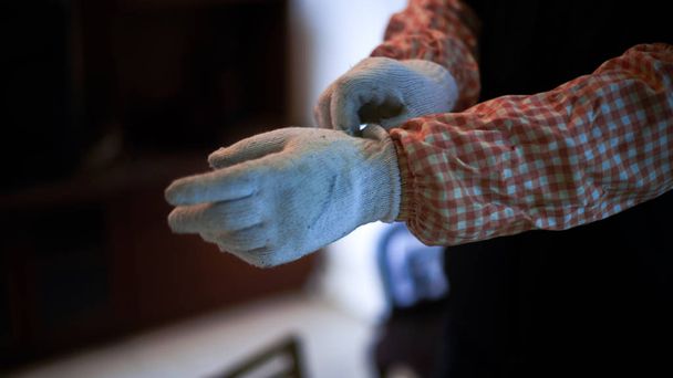 A decoration worker who is wearing protective gloves preparing for construction - 写真・画像