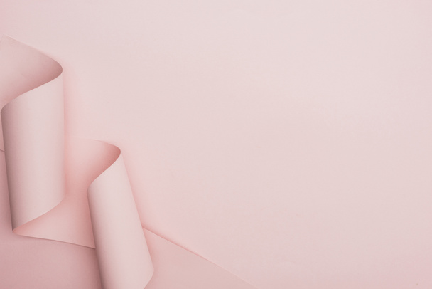 top view of pink paper swirl on pink background - Φωτογραφία, εικόνα