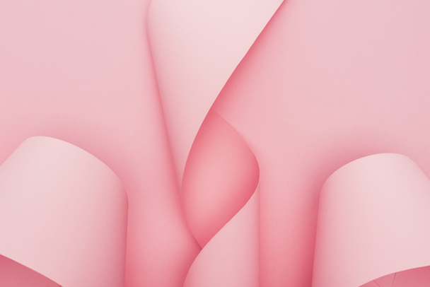 top view of pink paper swirls on pink background - Foto, Imagen