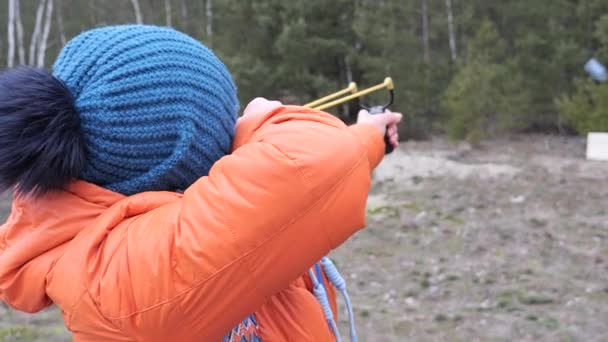 Young woman shoots a slingshot in nature 2020 - Footage, Video