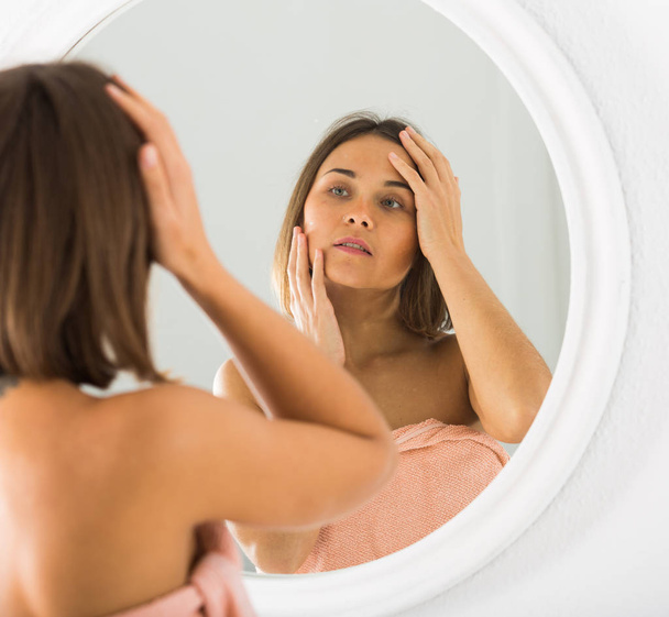 Woman using mirror - Foto, imagen