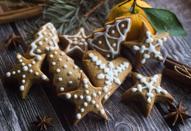 Tasty gingerbread cookies on the table. Christmas cookies and orange - 写真・画像