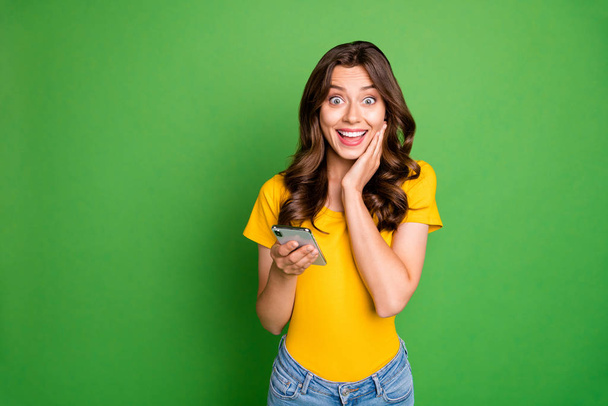 Portrait of her she nice attractive lovely charming cheerful cheery wavy-haired girl using 5g app fast speed internet online isolated over bright vivid shine vibrant green color background - Photo, image