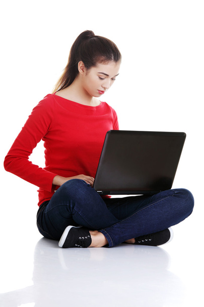 Happy young woman using her laptop - Zdjęcie, obraz