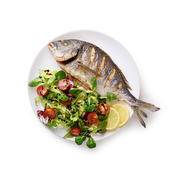 Grilled dorada fish on white plate - Φωτογραφία, εικόνα