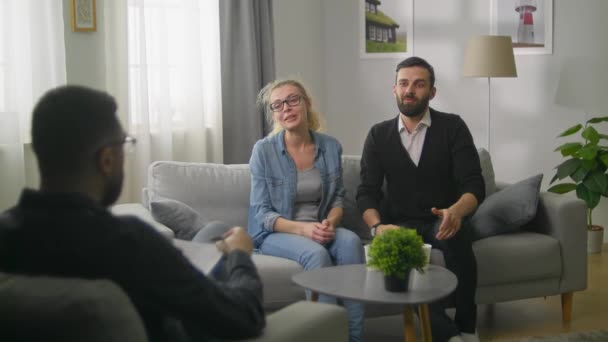 Young couple in consultation with a psychotherapist. An awkward situation. - Footage, Video