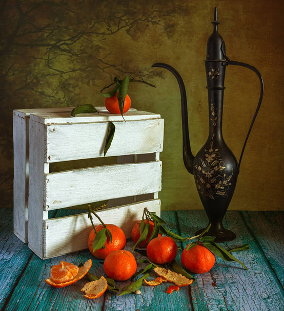 Still life with tangerines, a jug and a box. Ripe citrus fruits. Delicious food, drink or dessert. - Photo, Image
