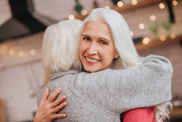 Two mature grey-haired positive ladies looking happy - Valokuva, kuva
