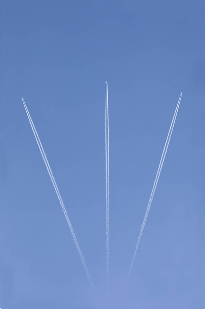three aircrafts in the ski make a graphic sign with condensation trails with copy space for your text - Photo, Image