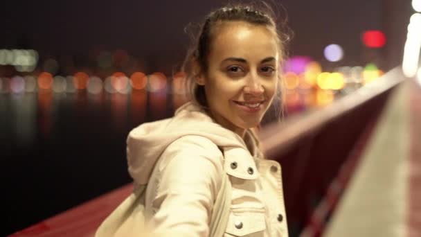 POV - slowmotion of beautiful smiling young woman walking outdoors night city. - Materiaali, video