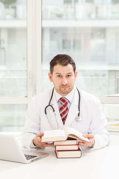 Male doctor is studying - Фото, изображение