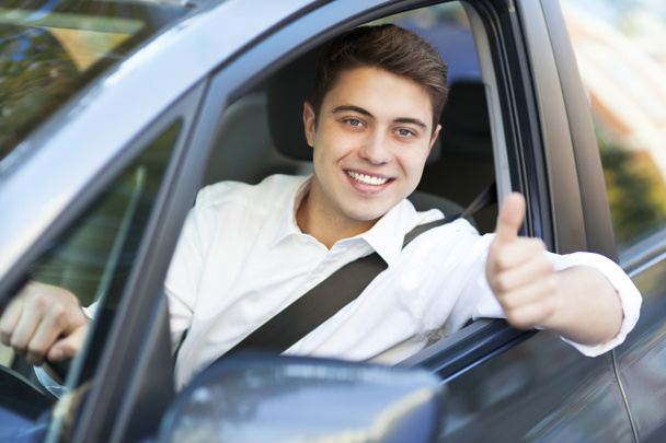 Man in a car with thumbs up - Fotó, kép