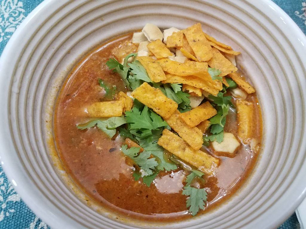 red soup in bowl with cilantro and chips - Photo, image