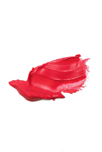 Lápiz labial rojo manchado aislado sobre fondo blanco - Foto, imagen