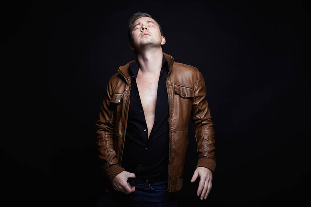 Fashionable young Man in leather coat - 写真・画像