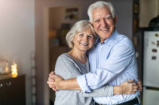 Happy senior couple embracing in their home  - Foto, Imagem