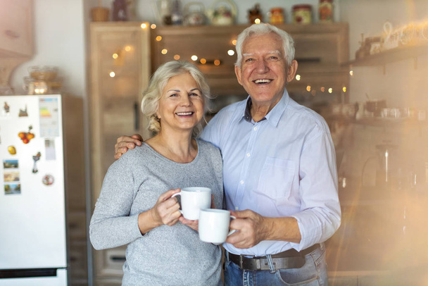 Happy senior couple embracing in their home  - Foto, afbeelding
