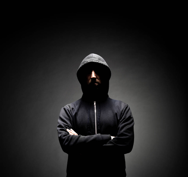 Portrait of computer hacker in hoodie. Obscured dark face. Data thief, internet fraud, darknet and cyber security concept. - Foto, Bild