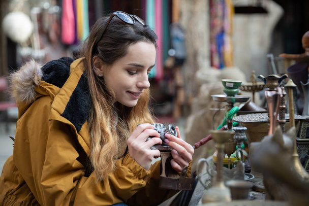 Photo of young tourist girl exploring streets of Baku. Moody photos of teenager girl visiting old city and taking photos of the city. - Photo, Image