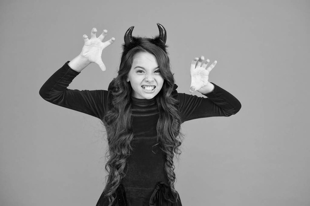 Halloween costumes designed after supernatural figures. Little devil. Little girl red horns celebrate Halloween. Carnival concept. Small child with imp style accessory Halloween party. Trick or treat - Фото, изображение