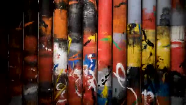 Close up of interesting composition with rotating tubes with bright paintings. Concept. Spinning columns, art object inside the modern art museum. - Footage, Video