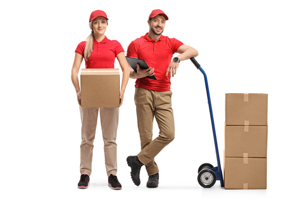 Delivery man and woman with boxes and a hand truck  - Zdjęcie, obraz