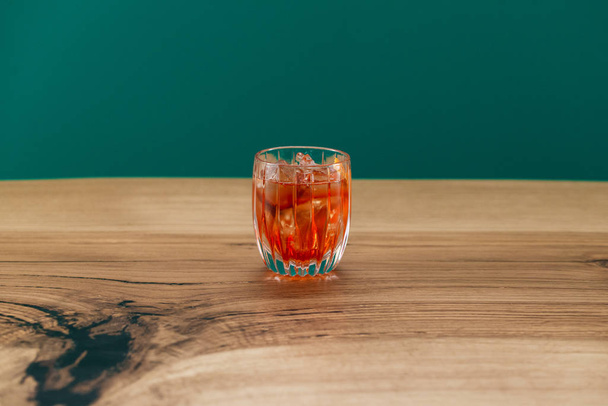 delicious orange color cocktail with ice and lemon slices - Photo, Image