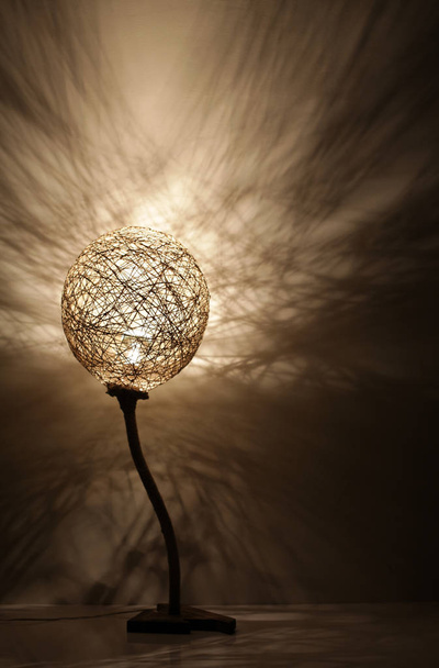 Handmade Wood and Rope Lamp with shadows on the wall - 写真・画像